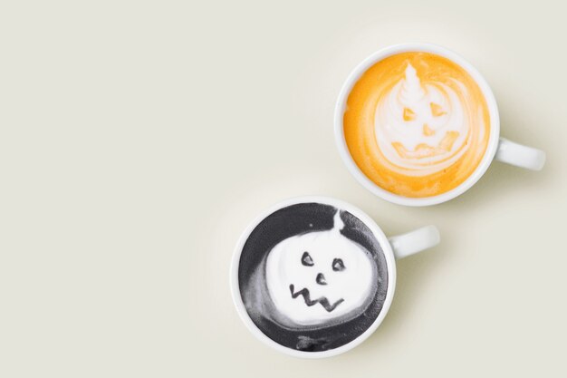 Coffee cup with  halloween pumpkin on pale background