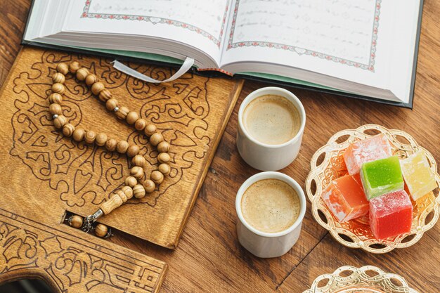 Coffee cup with oriental sweets on wooden table close up