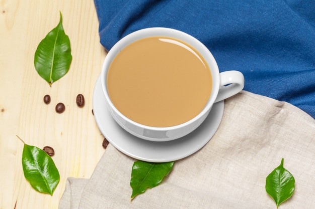 Coffee cup with saucer on a wooden background top view