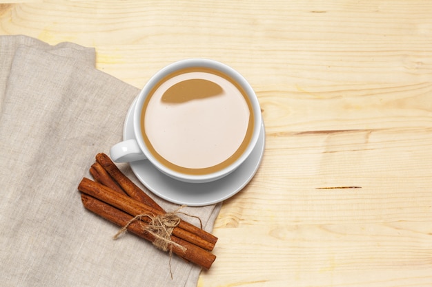 Coffee cup with saucer on a wooden background top view