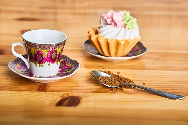 coffee cup with traditional turkish pattern and cake on the brown wooden table with spoon of coffee