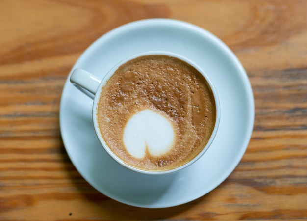 Coffee cup on wood table background