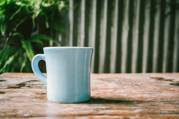 Coffee cup on wooden table background