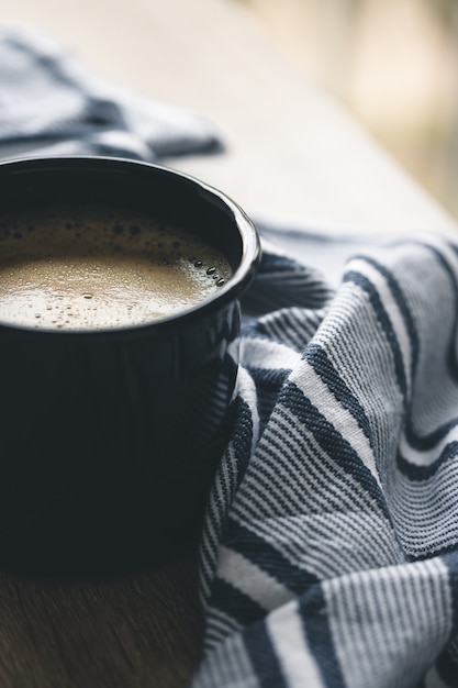 A coffee in a dark camping mug