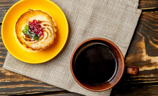 木材の背景にコーヒーとおいしいマフィン