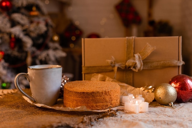 coffee in a designer mug and homemade honey cake on a wooden table in a New Year atmosphere