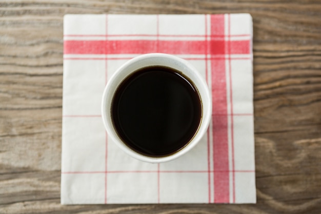 Coffee in disposable cup with tissue paper