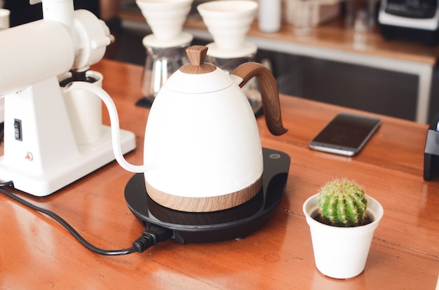 Coffee drip kettle on wooden table