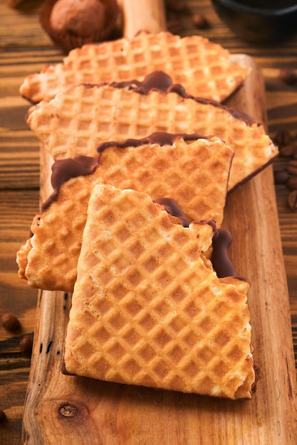 Coffee and dutch waffles Espresso coffee and dutch waffles or syrupwaffles cookies with chocolate on old wooden table Perfect syrupwaffles cookies for Breakfast Top view Mock up