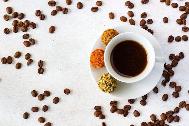 Coffee espresso and truffles balls on the plate, coffee and dessert