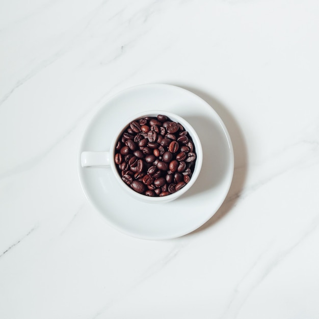 Coffee espresso in white cup of marble table background Top view Copy space