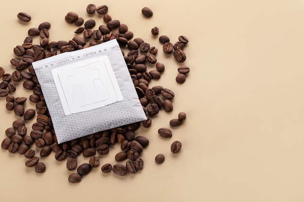 coffee filter or drip coffee with beans on a beige background