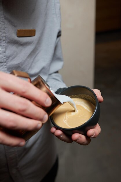 Coffee a full cup of coffee with milk on the table flower pattern figure which made with crema