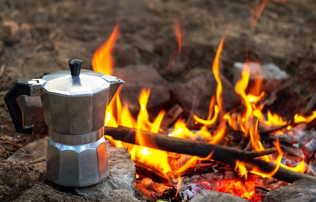 Coffee in a geyser over a fire. Geyser with coffee in nature.