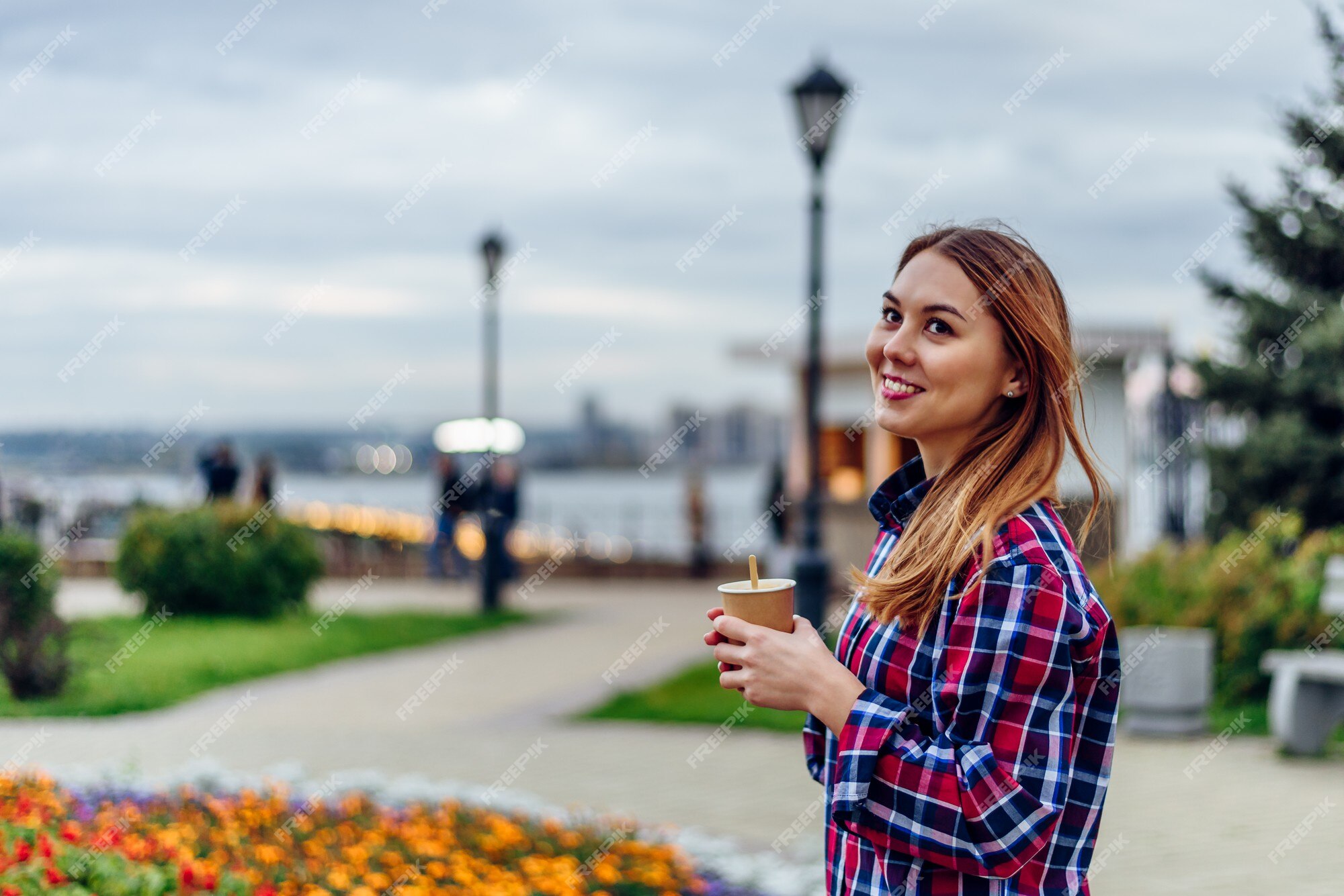 Coffee On The Go. Beautiful Young Woman Holding Coffee Cup And
