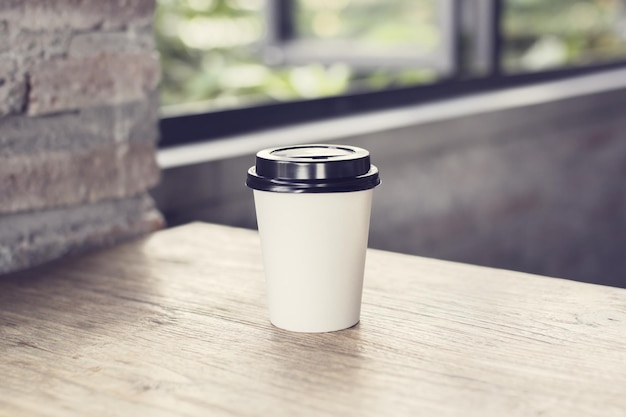 Coffee to go on a wooden table