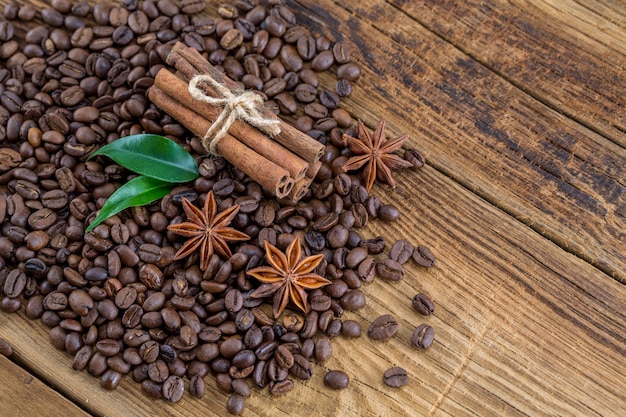 Coffee grains, anise and canella on old planks