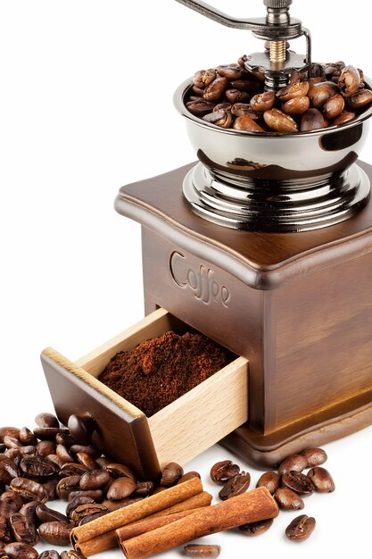 Coffee grinder with coffee beans and cinnamon