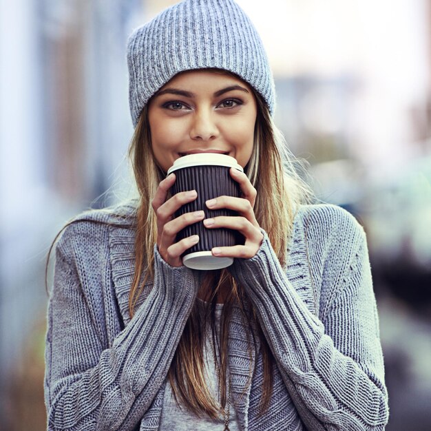 coffee happy and portrait of woman in city with drink caffeine beverage and cappuccino in street travel relax and person with latte in urban town walking in road for commute tourism and holiday