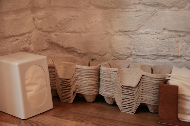 Coffee holders and napkins on wooden table in cafe