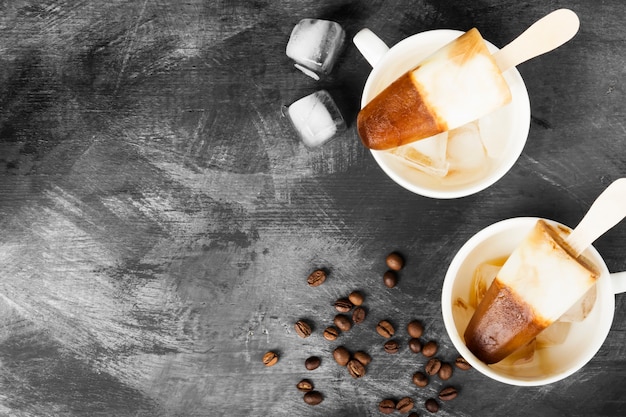 Coffee ice cream popsicles in white cups