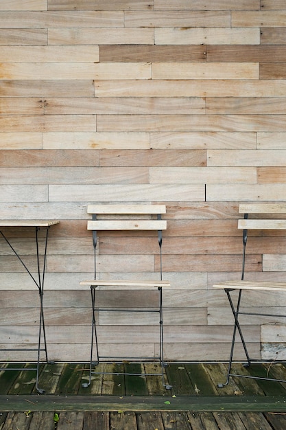 Coffee interior decoration from natural materials table and\
chairs against the wooden wall of the restaurant idea for the\
exterior vertical frame