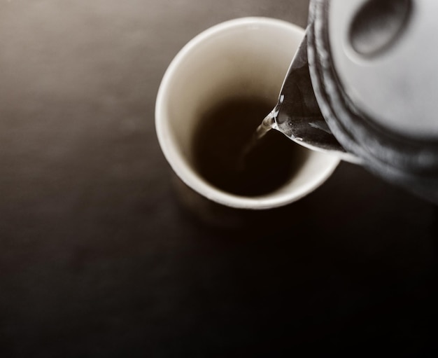 Coffee is poured from a teapot