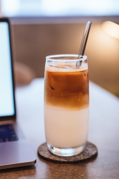 Photo coffee and laptop on wooden table background. use in traditional chinese alphabet operating system.