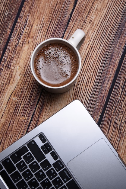 coffee and laptop on a wooden table