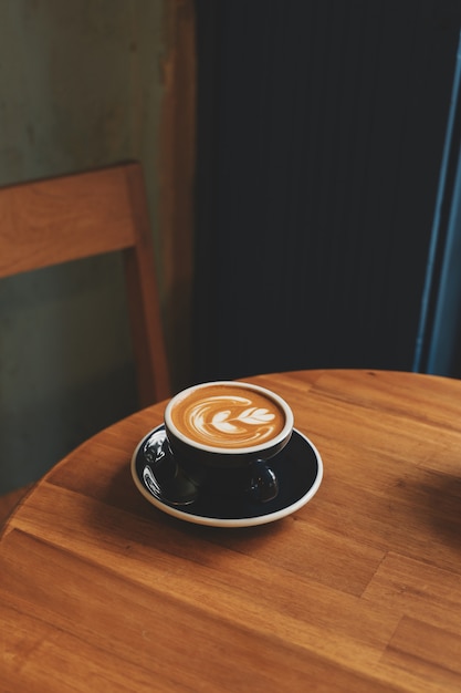 Coffee latte art in coffee shop in vintage color tone