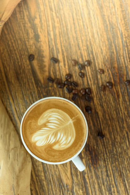 Coffee latte art on wooden table.