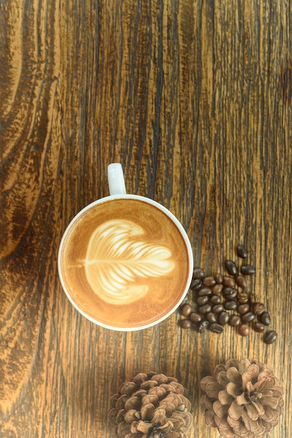 Coffee latte art on wooden table.