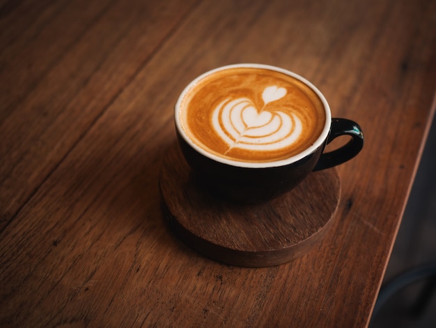 Coffee latte on the wood desk in cafe