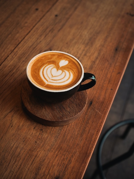 Coffee latte on the wood desk in cafe