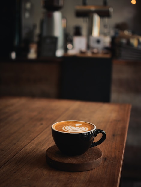 Coffee latte on the wood desk in cafe