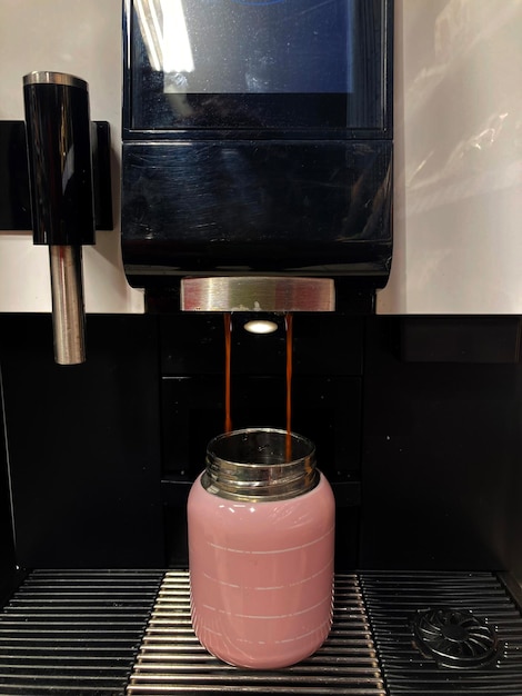 coffee machine prepares coffee in a thermos