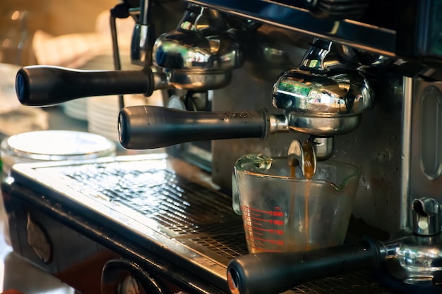 Coffee machine preparing espresso coffee in cafe