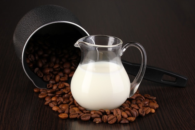 Photo coffee maker and milk on brown table