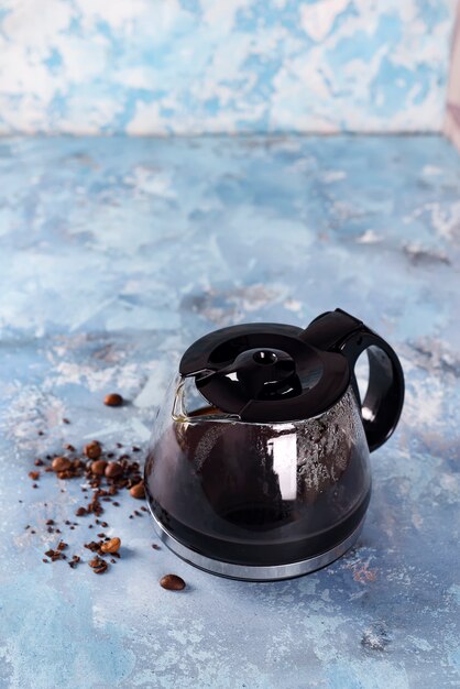 Coffee maker pot filling with coffee beans