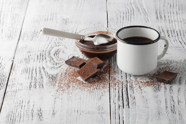 Coffee in a metal cup, standing on a wooden table