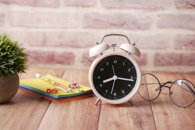 Coffee mug and clock on table close up