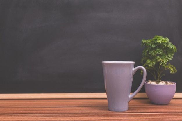 Coffee mug on the desk Blackboard. The concept of love to drink