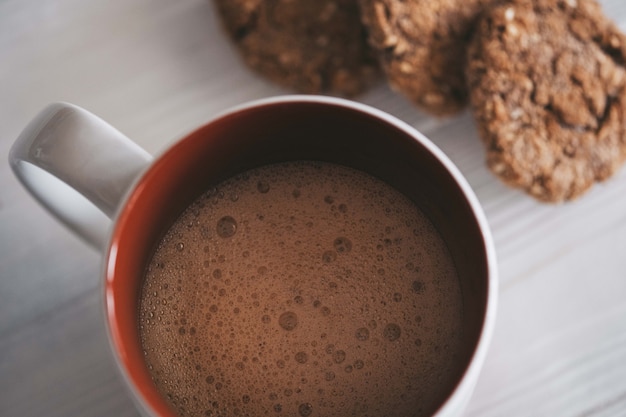 coffee in a mug and homemade oatmeal cookies