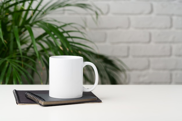 Coffee mug on table against brick wall