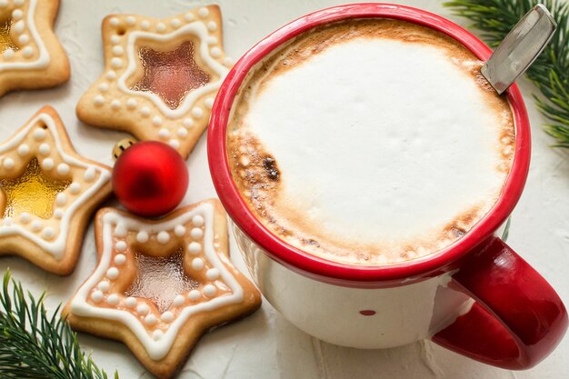 Coffee mug on table with homemade Christmas star shape sugar caramel cookies