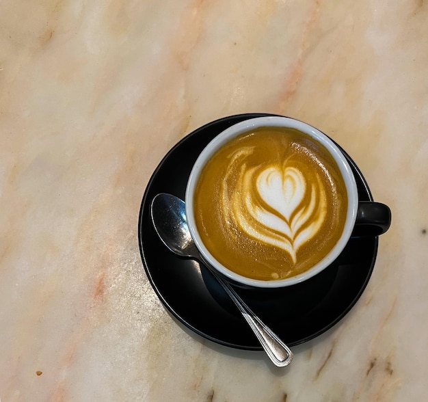 Coffee mug with milk on marble table copy space concept