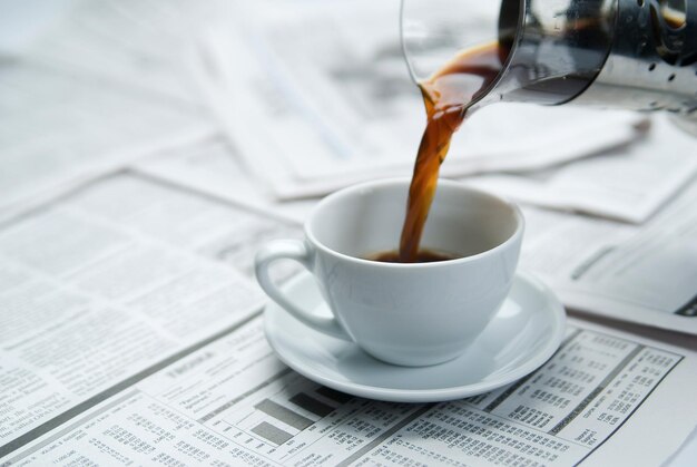 Coffee over newspaper