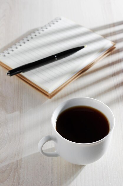 Coffee and notepad with pen