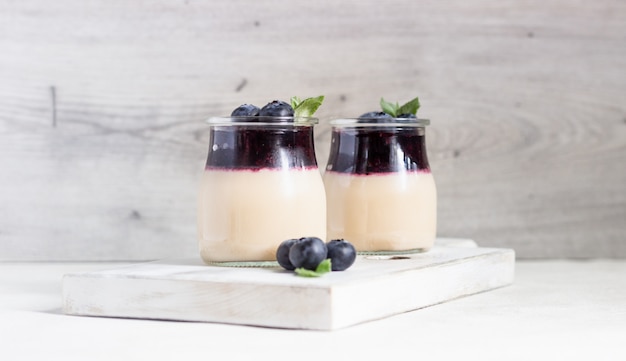 Coffee panna cotta with berry coulis and blueberries