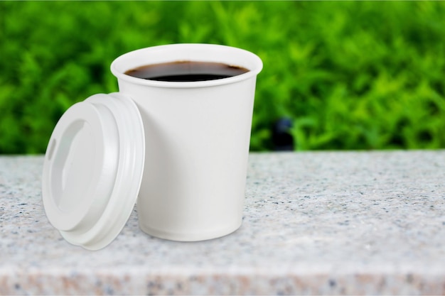 Coffee in paper cup on  background